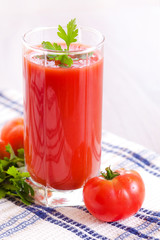Glass of fresh tomato juice on the table