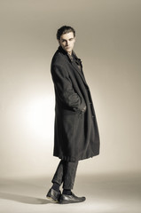 Full body fashion Shot of a young man in coat- professional model.