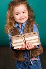 Little girl with books.