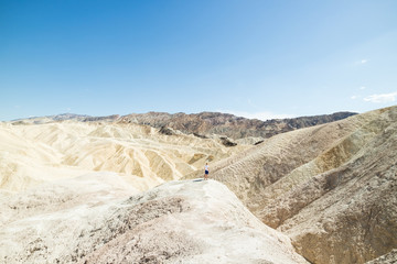 Man overlooking dry and arid sand dune landscape in Death Valley National Park