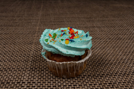 Blue cupcake with cream. Breakfast sweet tooth