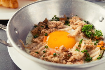 egg dish Breakfast served with fried egg, ham delicious.