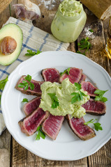 Beef steak with avocado dip and herbs