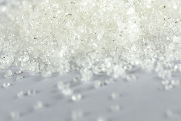 Closeup of white granulated sugar on Isolated White Background