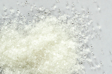 Closeup of white granulated sugar on Isolated White Background