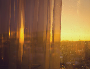 View the sunset from balcony through curtains