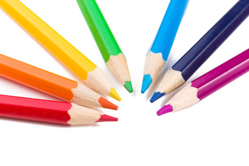 Many different colored pencils on white background