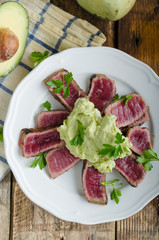 Beef steak with avocado dip and herbs