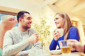 Obraz na płótnie Canvas happy couple meeting and drinking tea or coffee