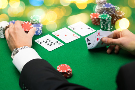 poker player with cards and chips at casino