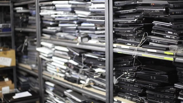 Rack Focus of Old Laptops on Shelves