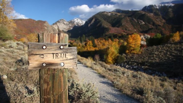 Hiking Trail Sign with Mountains in Background