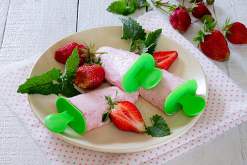Fruit ice-cream in a bowl on a wooden table