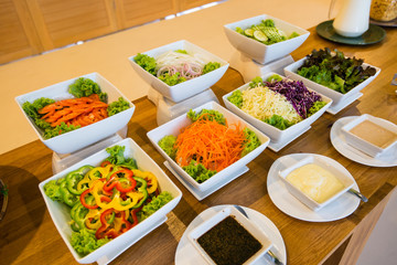 Salad bar with a variety of vegetables served buffet.