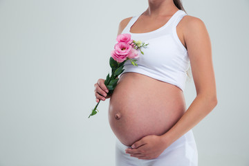 Closeup portrait of a pregnant woman holding flower