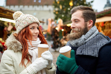 happy couple drinking coffee on old town street