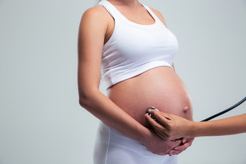 Pregnant woman being examine with stethoscope