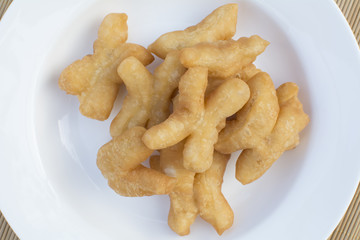 deep-fried dough stick on white dish