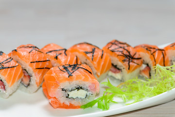Close-up of a white plate with sushi set -  salmon with strawber