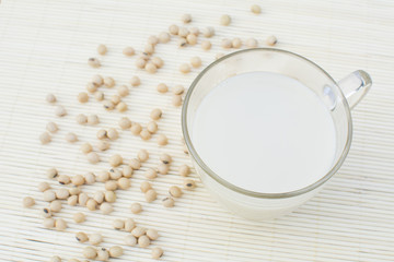 a cup of soy milk and soybeans