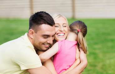 happy family hugging outdoors