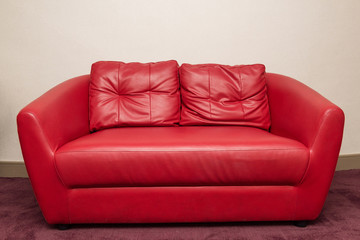 Red sofa in the room, white wall
