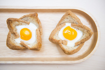 baked egg in bread bowl on wooden tray