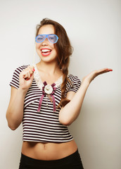 Playful young women holding a party glasses. 