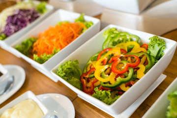 Salad bar with a variety of vegetables served buffet.