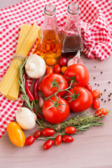 Ingredients for pasta: spaghetti, vegetables and spices on the old table.