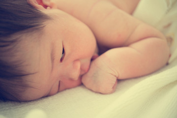 asian newborn on bed