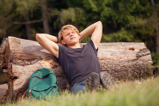 Young traveler rests time at the forest outskirt