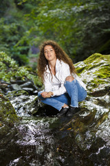Young European woman hiker by the river, outdoors activities