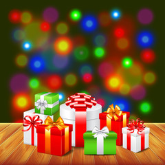 Obraz premium Christmas gifts on wooden table colorful background