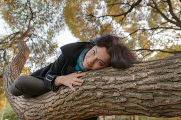girl lying on a tree trunk