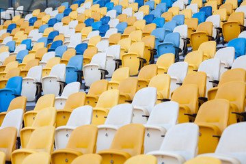 Fototapeta premium Close-up view of white, red and yellow stadium seats on Olympic stadium