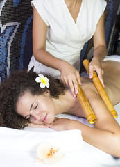 Obraz na płótnie Canvas Japanese massage with bamboo sticks in the spa salon