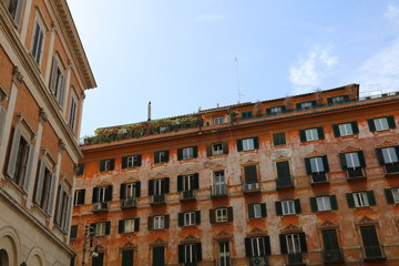 The windows and walls of the old house in the center of a European city