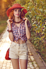 Beauty redhead woman smiling in the park, lifestyle, bokeh