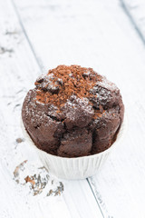 chocolate cake on white vintage wooden background, vertical