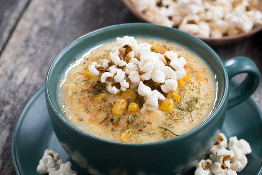 corn soup with popcorn in cup, closeup