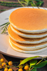 Stack of delicious pancake topped with maple syrup