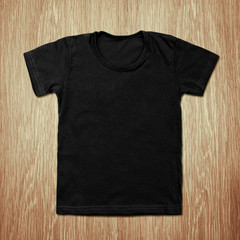 Black blank t-shirt on wooden background