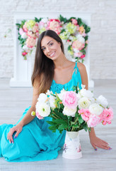 Beautiful young woman posing with white and pink bright flowers, spring time