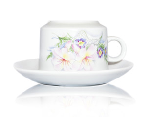 Elegant white cup and saucer with floral decorations