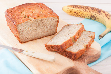 close up of banana bread on wooden chopping board