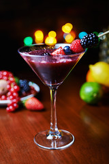 glass of tasty tropical cocktail with berries or lemonade.