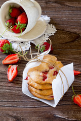 Cookies with strawberries on a wooden table