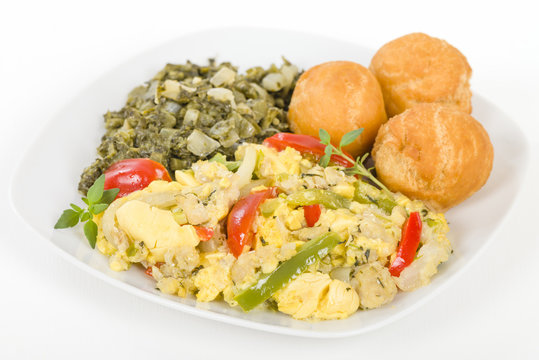 Ackee & Saltfish - Traditional Jamaican dish made of salt cod and ackee fruit. Served with callaloo and johnny cakes.
