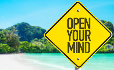 Open Your Mind sign with beach background